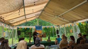 Dan Collins discussing the Science of Sleep at VarnFest Young Leaders in a tent.
