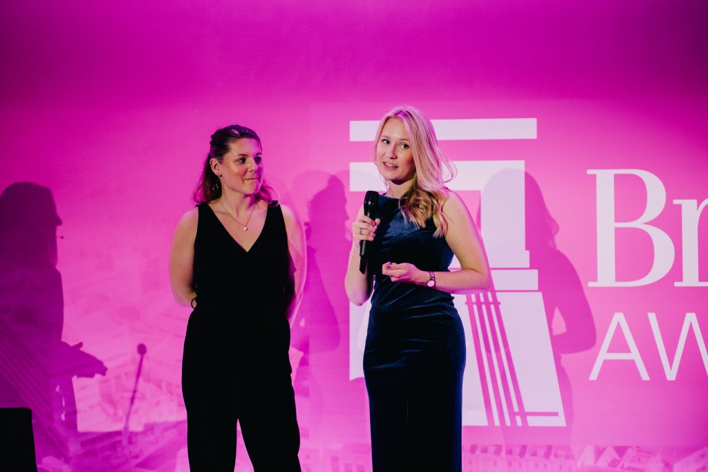 Floresco Managing Partners speaking on stage at an event.