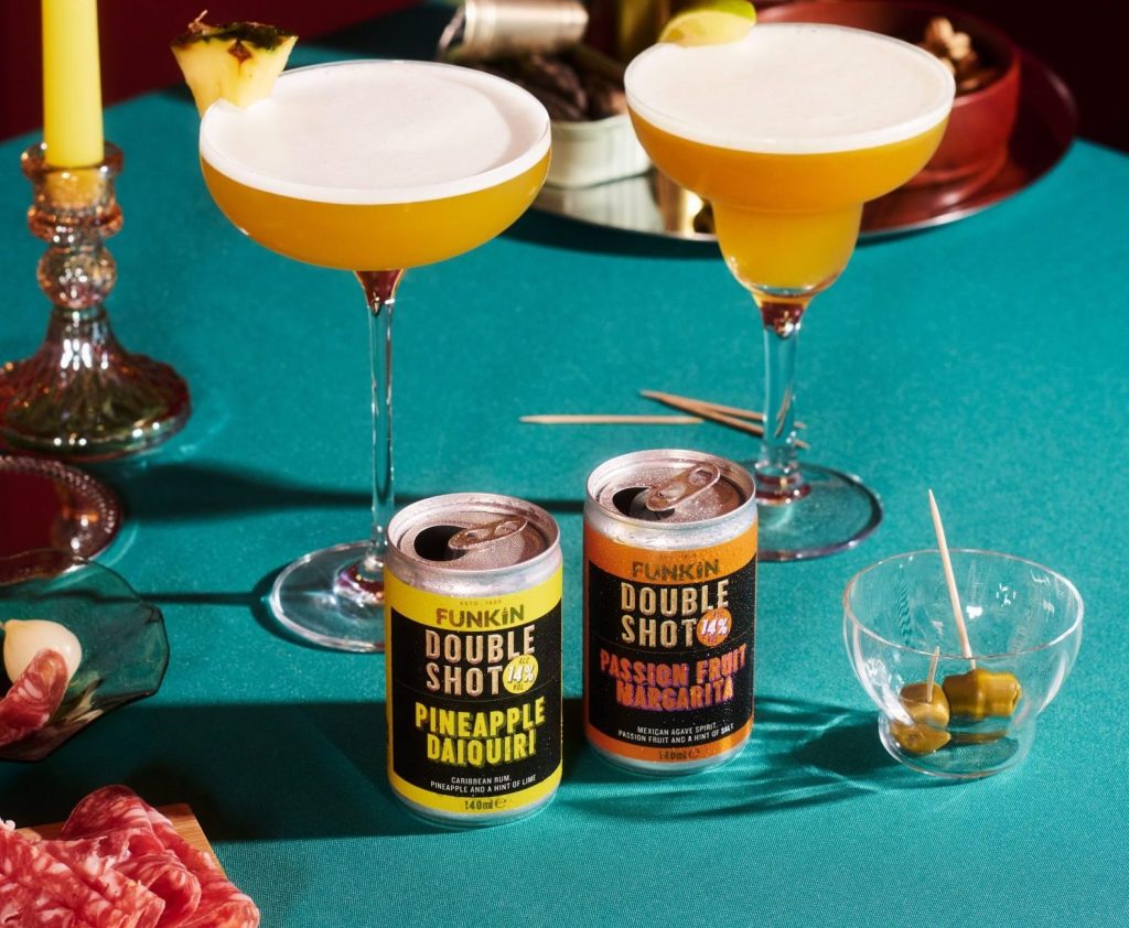 Photograph of a party scene featuring FUNKIN cocktail cans