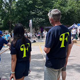 the back 2 people wearing floresco branded t-shirts