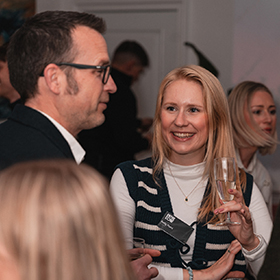 Crowd of people at corporate event, focused on smiling lady